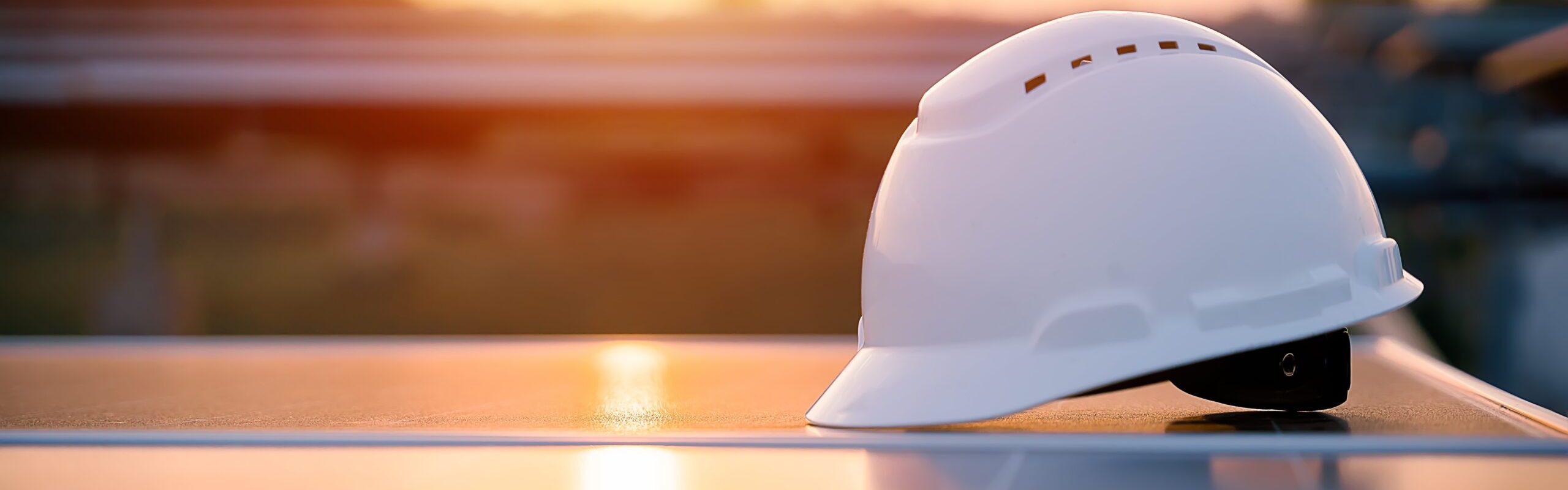 White,Safety,Hat,Placed,On,Solar,Panels,With,Sunset,In White,Safety,Hat,Placed,On,Solar,Panels,With,Sunset,In